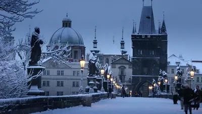 a city street covered in snow with buildings at Zizkov APT Prague by Michal&Friends in Prague