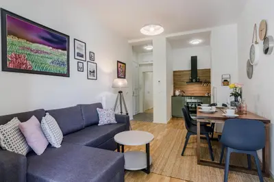 a living room and kitchen with a couch and a table at Zizkov APT Prague by Michal&Friends in Prague