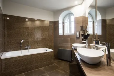 a bathroom with two sinks and a tub and a shower at Hotel SEN in Senohraby