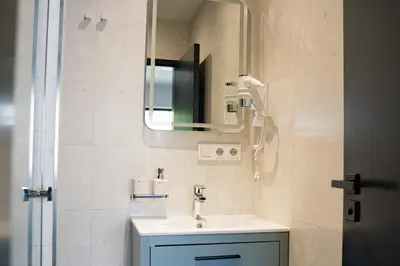 a bathroom with a sink and a mirror at Penzion Lesni in Milovice