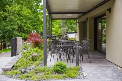 a patio with a table and chairs on it at Penzion Lesni in Milovice