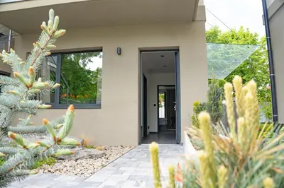 a house with a cactus in the front yard at Penzion Lesni in Milovice