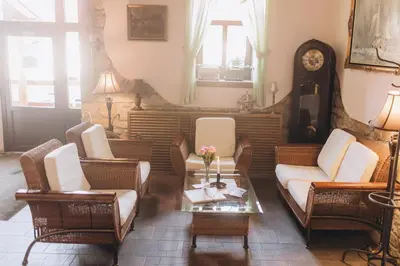 a living room with couches and chairs and a table at Hotel Lony in Mochov