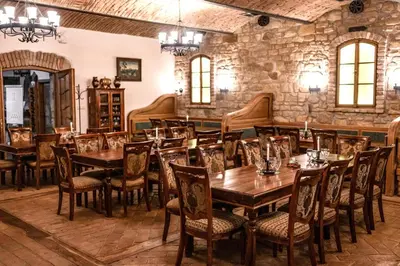 a dining room with wooden tables and chairs at Hotel Lony in Mochov