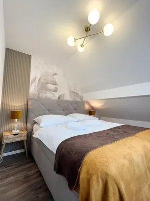 a bedroom with a large bed in a room at Hotel Lony in Mochov