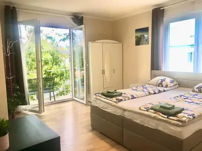 a bedroom with two beds and a balcony at Fresh house in Prague