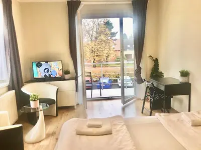 a living room with a bed and a table and a piano at Fresh house in Prague
