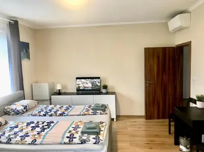 a bedroom with two beds and a flat screen tv at Fresh house in Prague