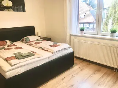 a bedroom with a bed with a black frame and a window at Fresh house in Prague