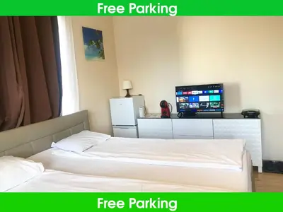 a hotel room with two beds and a television at Fresh house in Prague