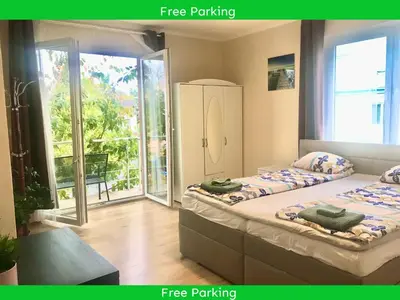 a bedroom with two beds and a balcony at Fresh house in Prague