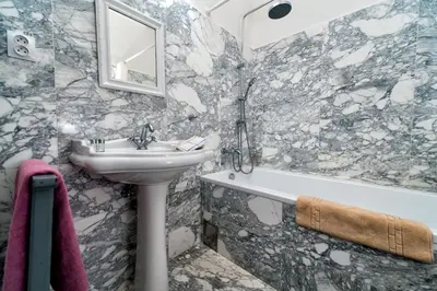 a bathroom with a sink and a bath tub at Family Hotel Okoř in Okoř