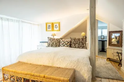a bedroom with a large bed and a table at Family Hotel Okoř in Okoř