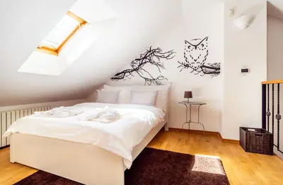 a bedroom with a white bed in a attic at 4BR 3BATH BALCONY central Harry Potter penthouse in Prague