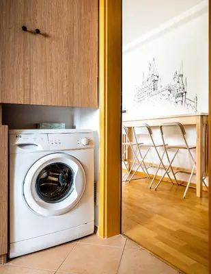 a washer and dryer in a room with a kitchen at 4BR 3BATH BALCONY central Harry Potter penthouse in Prague