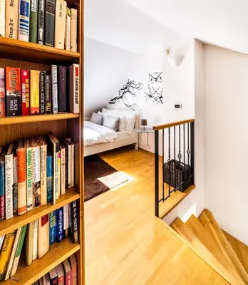 a room with bookshelves filled with books at 4BR 3BATH BALCONY central Harry Potter penthouse in Prague