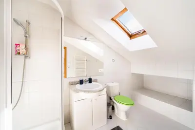 a white bathroom with a sink and a toilet at 4BR 3BATH BALCONY central Harry Potter penthouse in Prague