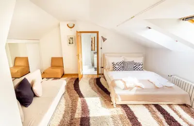 a bedroom with a bed and a couch at 4BR 3BATH BALCONY central Harry Potter penthouse in Prague