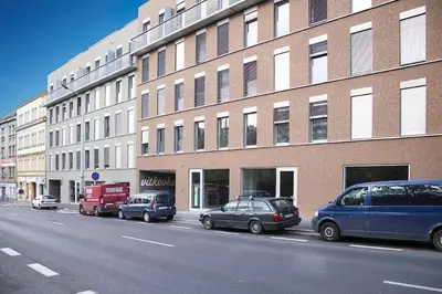 a row of cars parked in front of a building at Bright Studio, 10min Centre, Free Parking in Prague