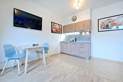 a bathroom with a sink and a washing machine at OL apartments in Prague