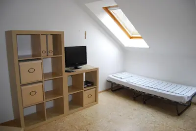 a room with a tv and a shelf with a television at Apartmany U Stareho Labe in Nymburk