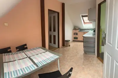 a small kitchen with a table and a counter at Apartmany U Stareho Labe in Nymburk