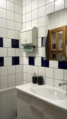 a white bathroom with a sink and a mirror at U Anny Šmejdířky in Nymburk