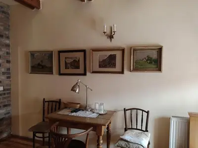 a dining room with a table and chairs and a lamp at U Anny Šmejdířky in Nymburk