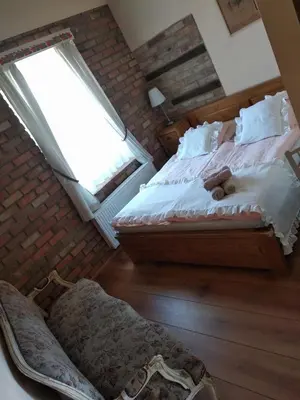 a bedroom with a bed with a teddy bear on it at U Anny Šmejdířky in Nymburk