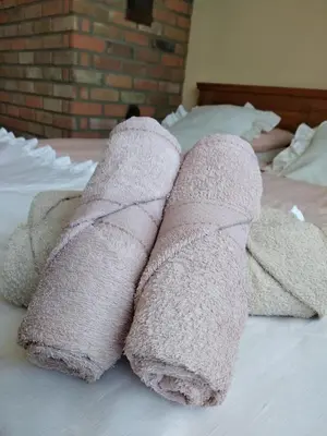 a pile of towels on top of a bed at U Anny Šmejdířky in Nymburk