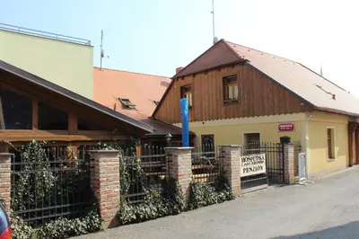 a building with a fence in front of a building at U Anny Šmejdířky in Nymburk