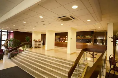 a lobby with a staircase in a building at Hotel Krystal in Prague