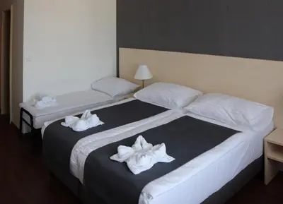 two beds in a hotel room with white towels on them at Hotel Krystal in Prague