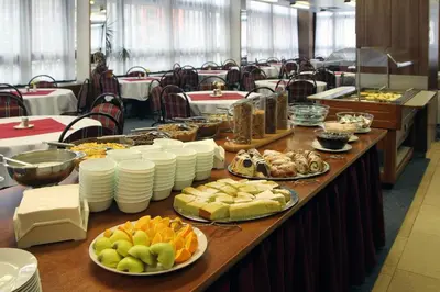 a long table with plates of food on it at Hotel Krystal in Prague