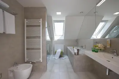 a bathroom with a shower with a glass door at Hotel Panská Zahrada in Dobřichovice