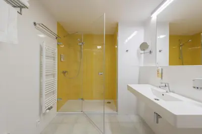 a bathroom with a shower and a sink at Hotel Panská Zahrada in Dobřichovice