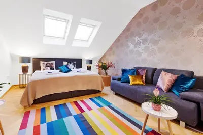 a living room with a bed and a couch at Royal Route Residence Lesser Town in Prague
