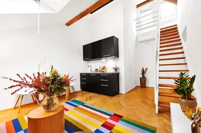 a living room with a television and a colorful rug at Royal Route Residence Lesser Town in Prague