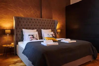 a bedroom with a large bed with two books on it at Royal Route Residence Lesser Town in Prague