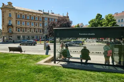 a group of people sitting on a bench in a park at Royal Route Residence Lesser Town in Prague