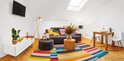 a living room with a couch and a colorful rug at Royal Route Residence Lesser Town in Prague