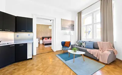 a living room with a couch and a table at Royal Route Residence Lesser Town in Prague
