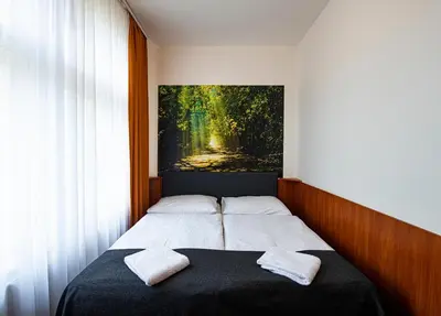 a bedroom with a bed with two pillows on it at Hotel Zlatá Váha in Prague