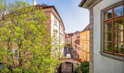 an alley way between buildings in a city at 3 Epoques Apartments by Adrez in Prague