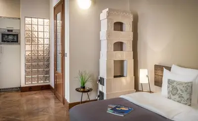 a bedroom with a bed and a book shelf at 3 Epoques Apartments by Adrez in Prague