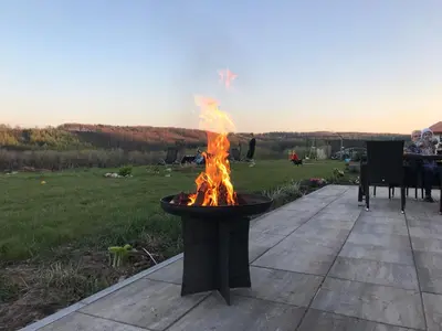 a fire pit on a patio with a table at Bílichov in Bílichov