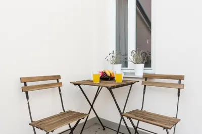 a table and two chairs next to a window at Prague Days - Sunny Riverside Apartments with Terraces in Prague