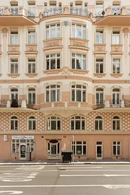 a large building with a street in front of it at Prague Days - Sunny Riverside Apartments with Terraces in Prague