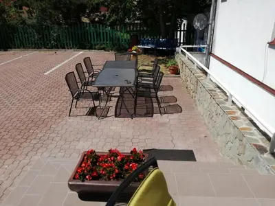 a patio with a table and chairs and flowers at Hotel O.K. 1 in Beroun