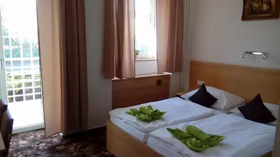 a bedroom with a bed with green pillows on it at Hotel O.K. 1 in Beroun